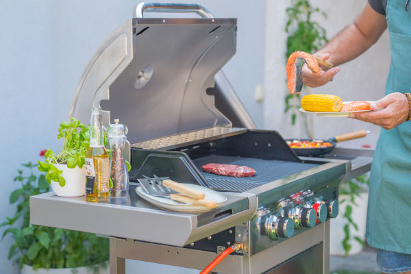 Nerezový plynový gril G21 California BBQ Premium line na zahrade s jidlem